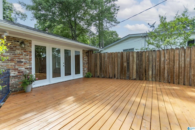 deck featuring french doors and fence