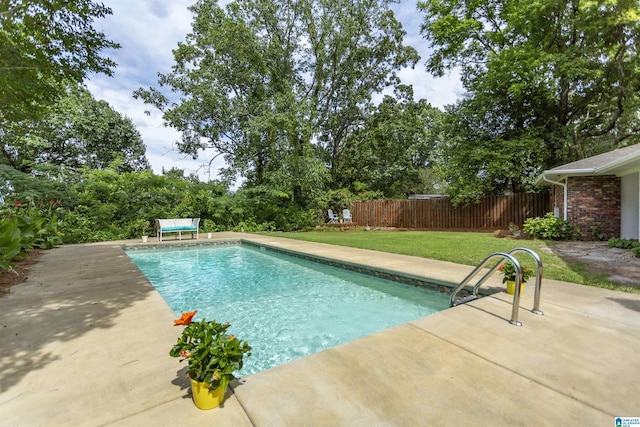 view of pool featuring a lawn, fence, and a fenced in pool