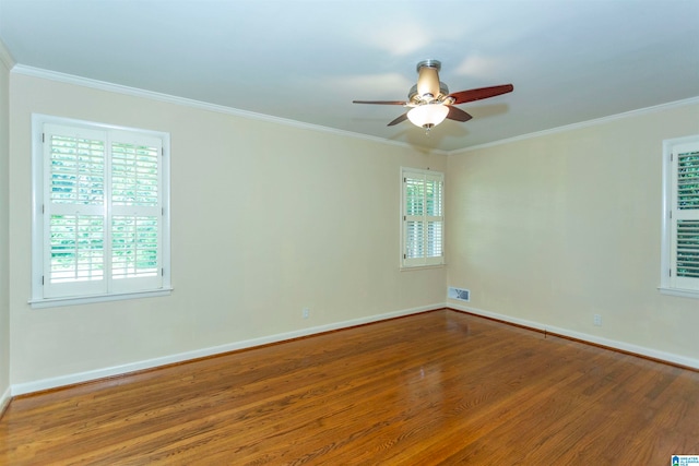 spare room featuring plenty of natural light, ceiling fan, and hardwood / wood-style flooring