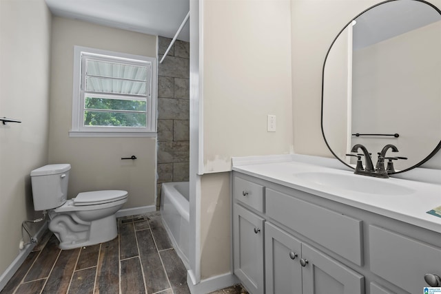 full bathroom with vanity, tiled shower / bath combo, and toilet