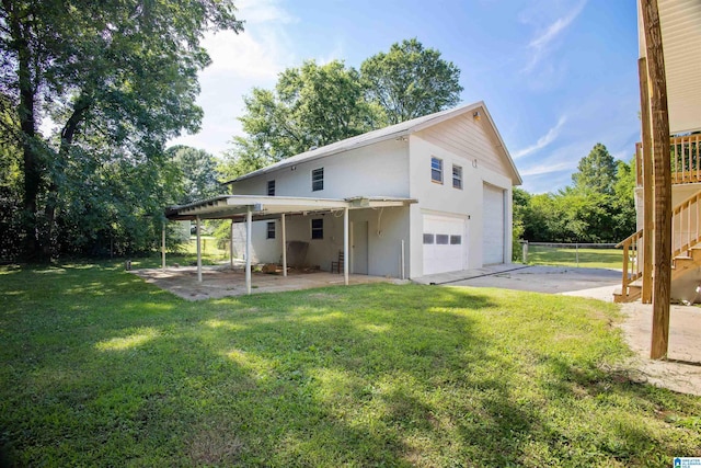 rear view of property featuring a yard and a garage