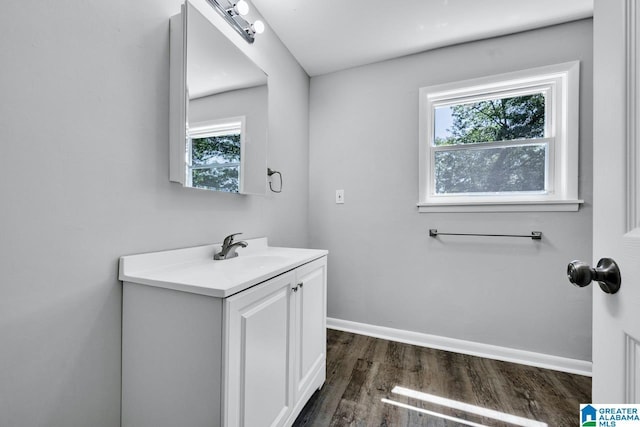 bathroom with hardwood / wood-style floors and vanity