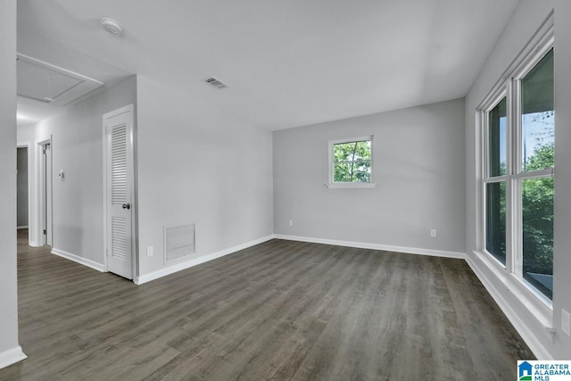 empty room with dark hardwood / wood-style flooring