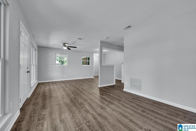 unfurnished living room featuring dark hardwood / wood-style floors and ceiling fan