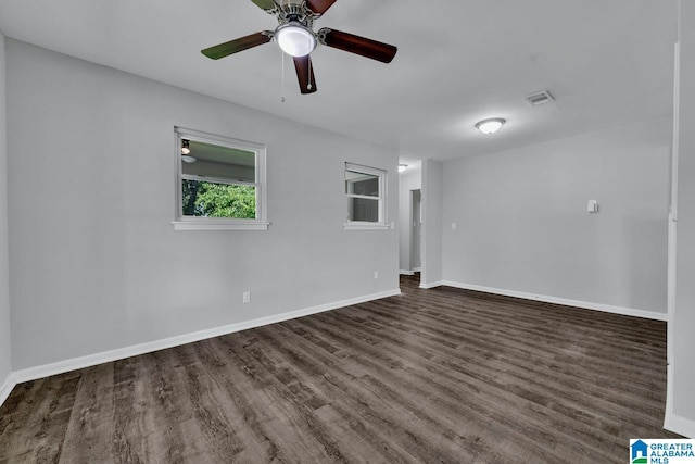 empty room with ceiling fan and dark wood-type flooring