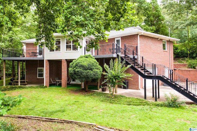 rear view of property with a patio and a lawn