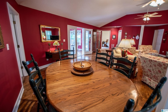 dining area featuring wood-type flooring, ceiling fan, and lofted ceiling