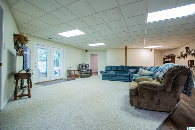 living room featuring a paneled ceiling, hardwood / wood-style flooring, and french doors