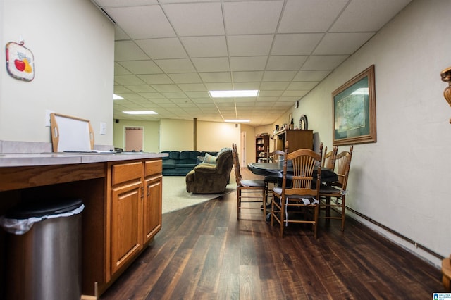 kitchen featuring wood-type flooring and a paneled ceiling