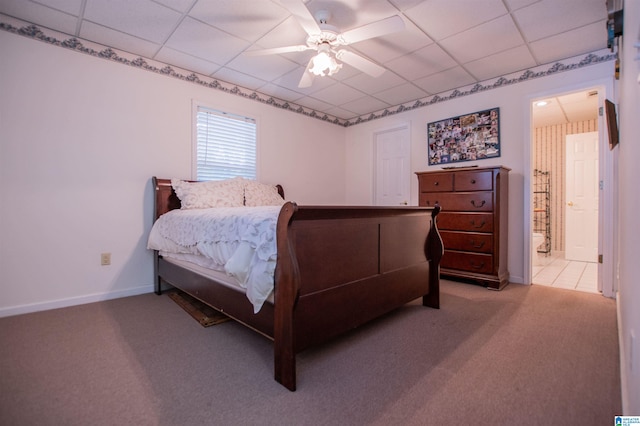 bedroom featuring tile flooring, ceiling fan, and a drop ceiling