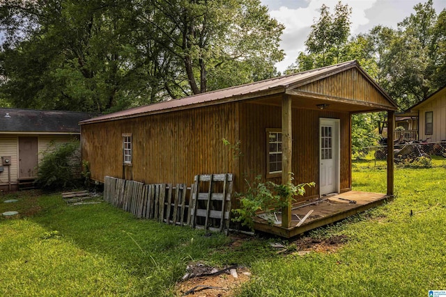 view of outdoor structure featuring a lawn