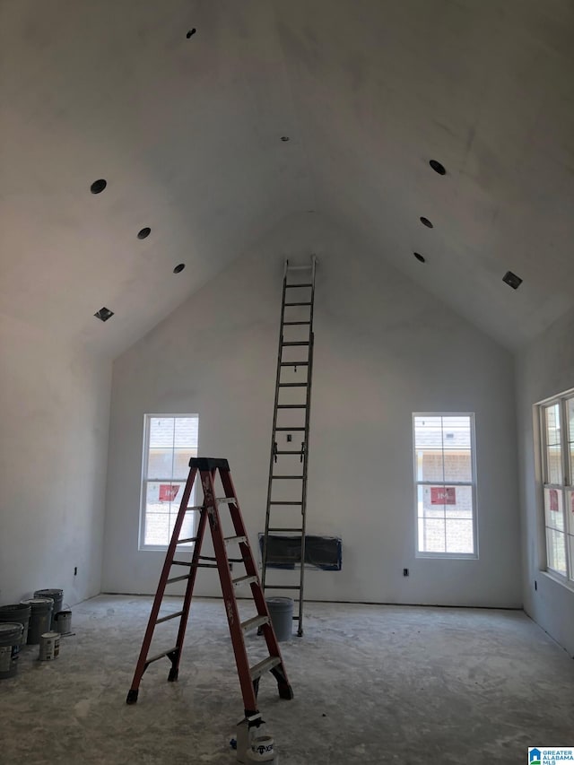 interior space featuring a healthy amount of sunlight and high vaulted ceiling