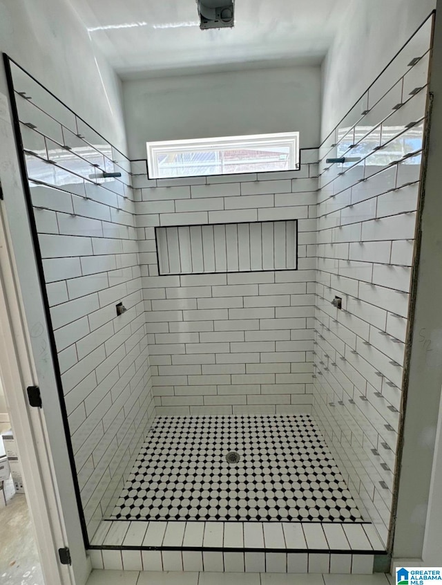 bathroom with a tile shower