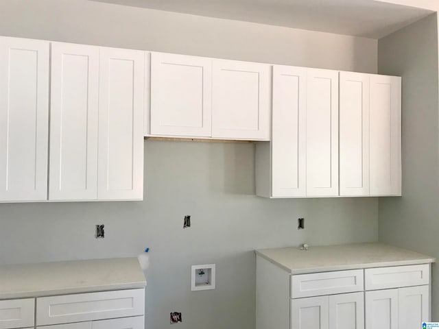 clothes washing area with washer hookup, cabinets, and gas dryer hookup