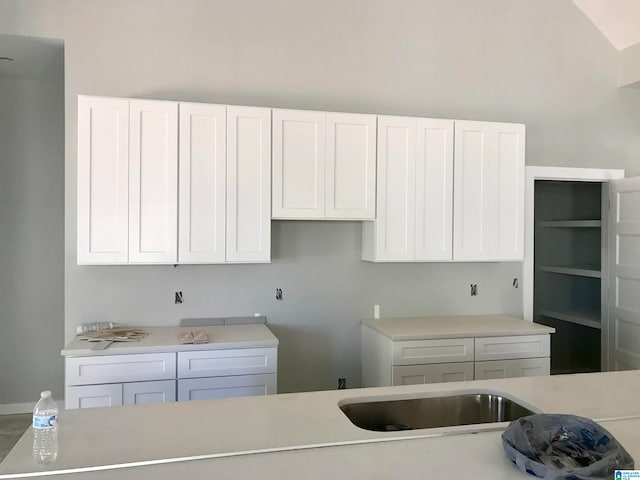 kitchen with white cabinets and lofted ceiling