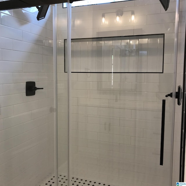 bathroom featuring a shower with shower door