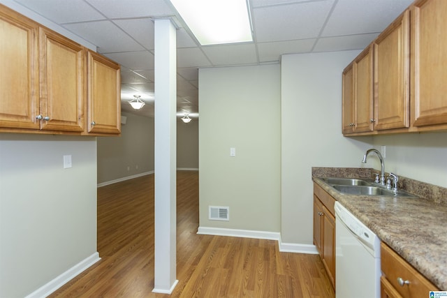 kitchen featuring a paneled ceiling, sink, white dishwasher, and light hardwood / wood-style flooring