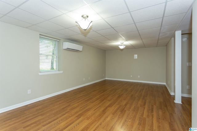 spare room with wood-type flooring and an AC wall unit