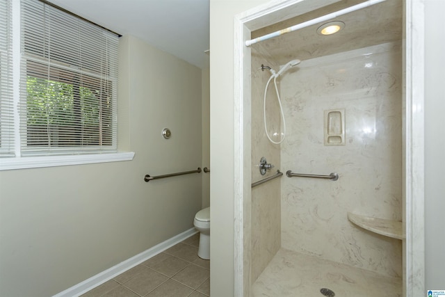 bathroom featuring toilet, tile patterned floors, and walk in shower