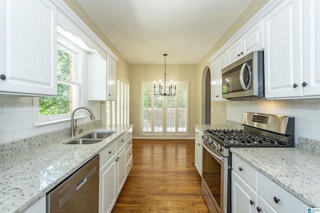 kitchen with white cabinets, appliances with stainless steel finishes, and sink