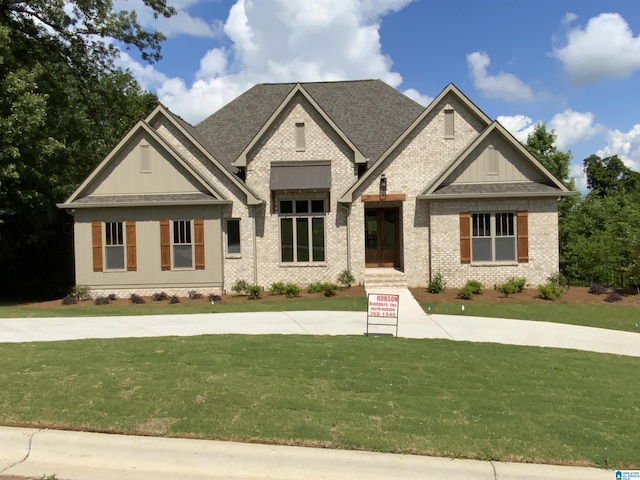 craftsman inspired home with a front lawn