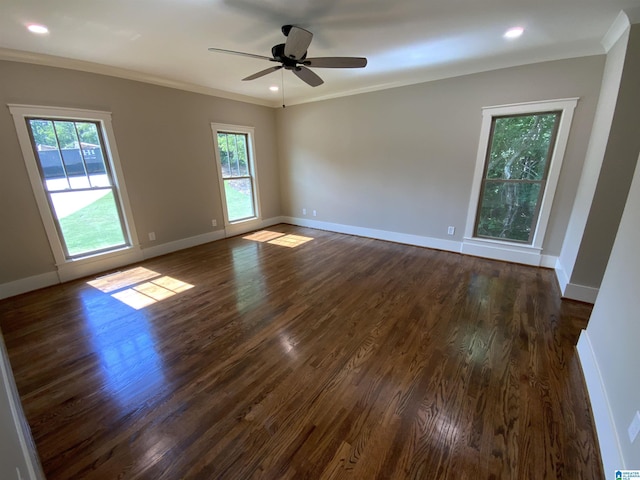 unfurnished room featuring ceiling fan, crown molding, and dark wood-type flooring