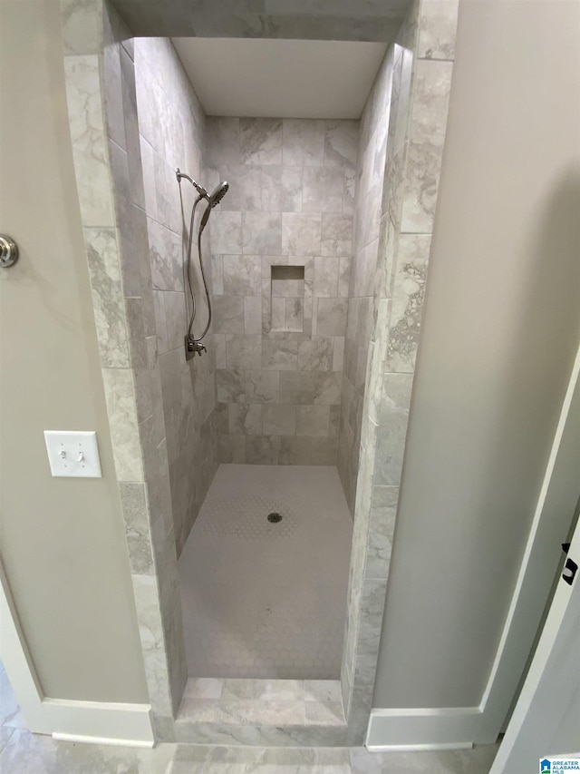 bathroom with a tile shower