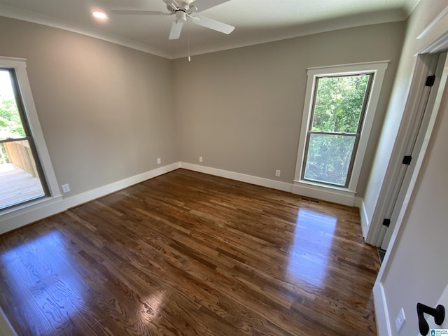 empty room with ceiling fan, ornamental molding, and dark wood-type flooring