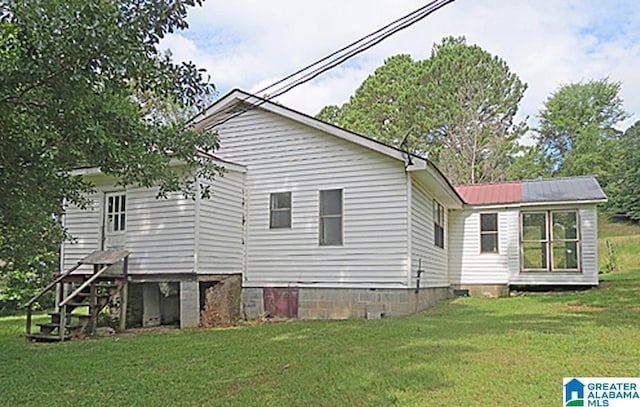 rear view of house featuring a yard