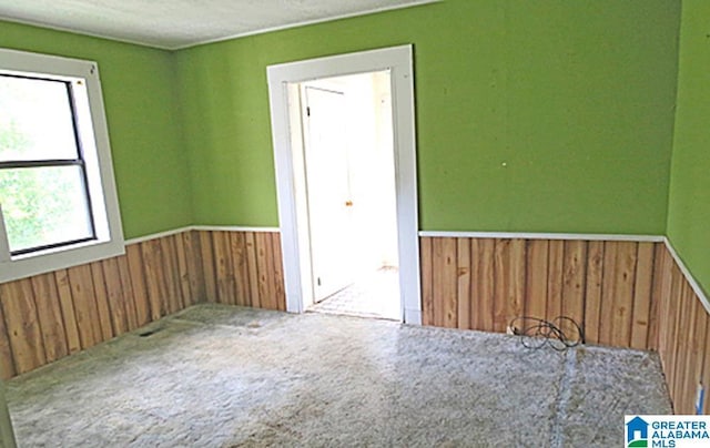 carpeted empty room with a textured ceiling