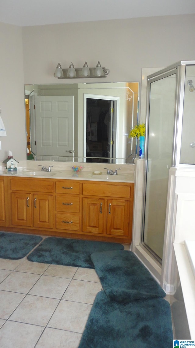 bathroom with walk in shower, tile floors, and dual bowl vanity