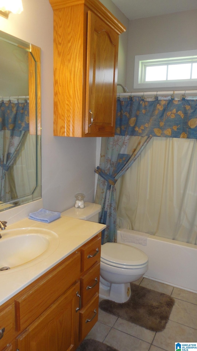 full bathroom featuring tile floors, shower / bath combination with curtain, toilet, and vanity