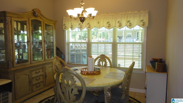 dining space featuring a healthy amount of sunlight, an inviting chandelier, and tile floors