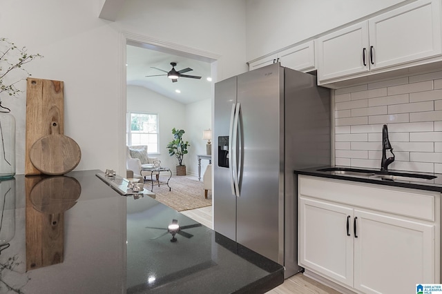 kitchen with white cabinetry, stainless steel fridge with ice dispenser, and sink