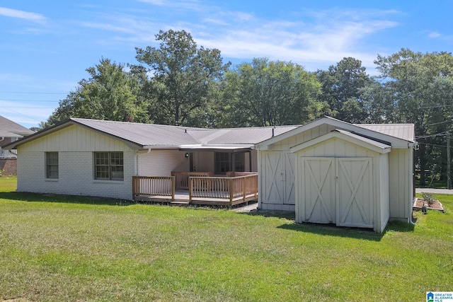 rear view of house featuring a lawn, a storage shed, and a wooden deck