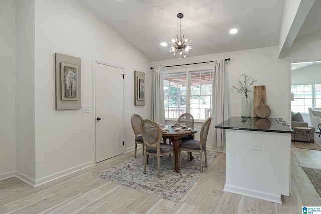 dining area featuring vaulted ceiling and a chandelier