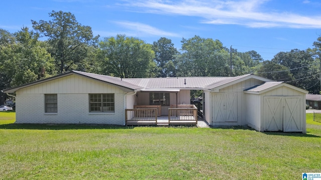 back of house featuring a yard, a storage unit, and a wooden deck