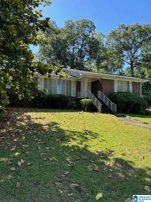 ranch-style home featuring a front yard