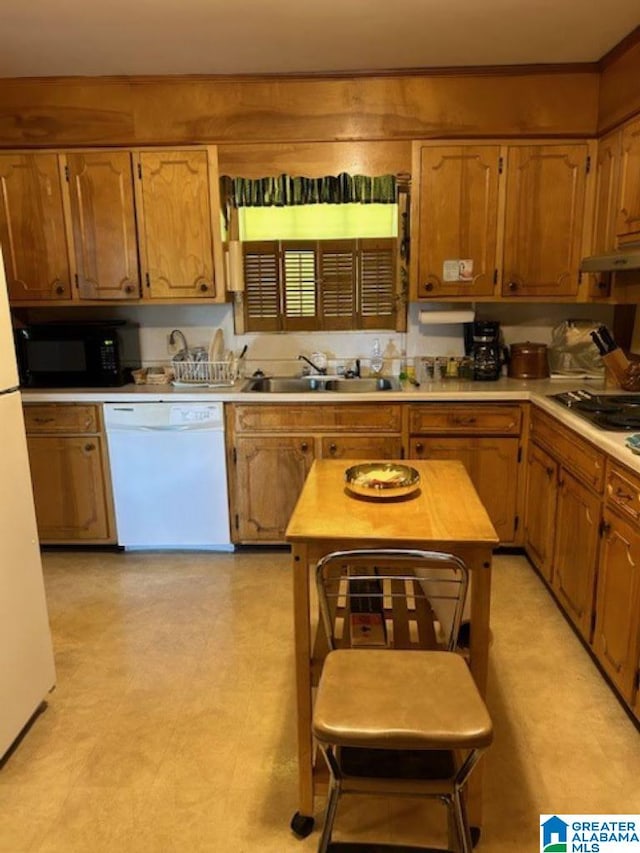 kitchen featuring white appliances and sink