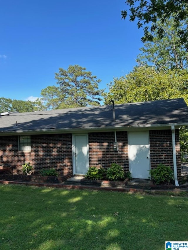 back of property featuring a lawn