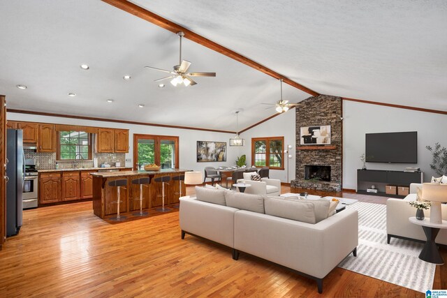 873 Buckelew Rd, Anniston, AL 36207 - living area featuring ceiling fan, light wood finished floors, a stone fireplace, ornamental molding, and recessed lighting
