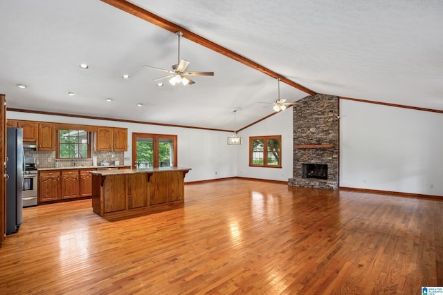 873 Buckelew Rd, Anniston, AL 36207 - kitchen featuring ceiling fan, a sink, brown cabinets, plenty of natural light, and crown molding