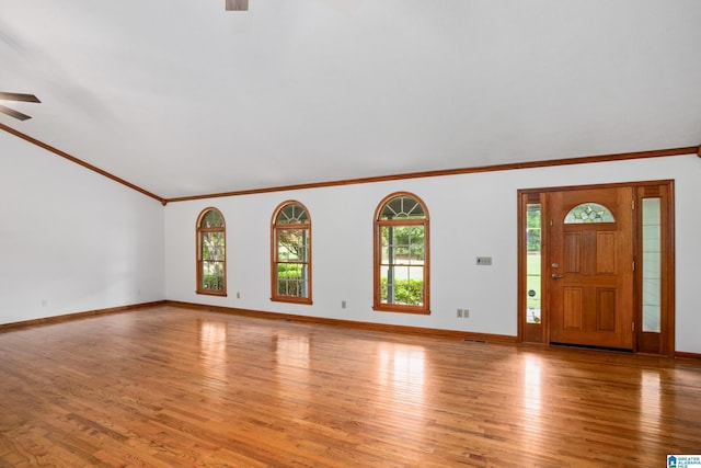 873 Buckelew Rd, Anniston, AL 36207 - unfurnished living room with a ceiling fan, crown molding, light wood-type flooring, baseboards, and lofted ceiling
