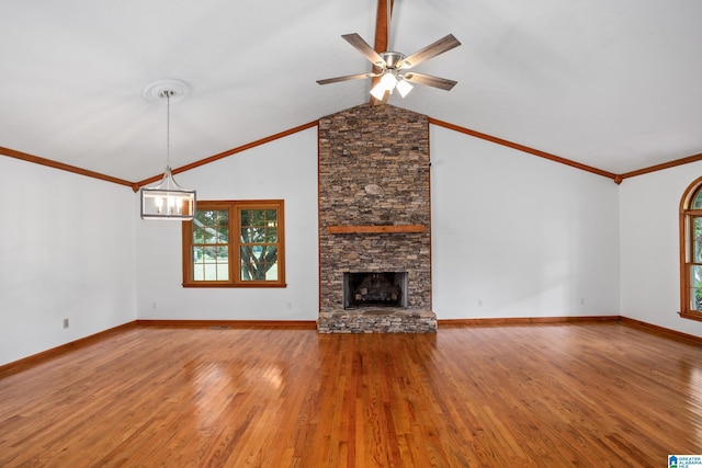 873 Buckelew Rd, Anniston, AL 36207 - unfurnished living room featuring wood finished floors, a fireplace, ceiling fan, lofted ceiling, and crown molding