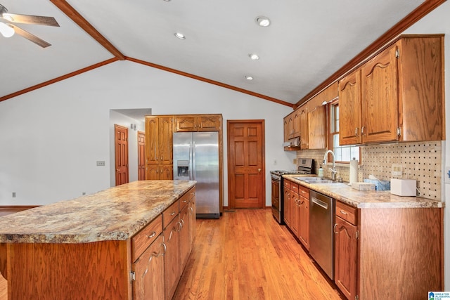 kitchen with sink, stainless steel appliances, tasteful backsplash, vaulted ceiling with beams, and a kitchen island