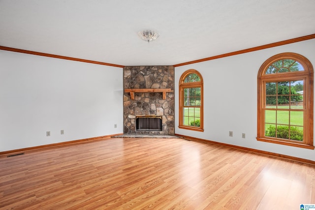 unfurnished living room with a fireplace, light hardwood / wood-style floors, and ornamental molding