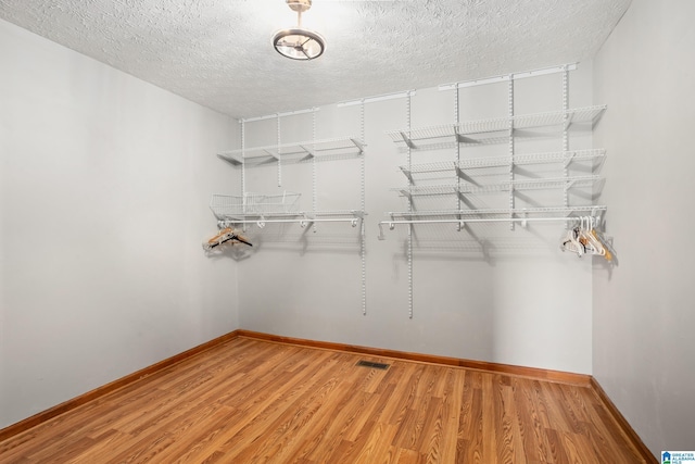 walk in closet featuring hardwood / wood-style floors