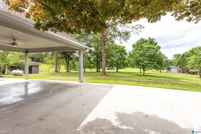 exterior space with a shed and ceiling fan