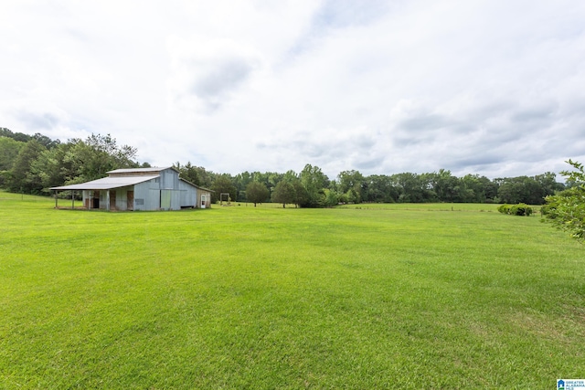 view of yard with a rural view and an outdoor structure