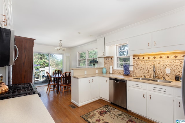 kitchen with decorative backsplash, white cabinetry, stainless steel dishwasher, and sink